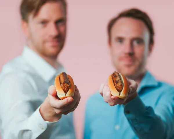Men holding hotdogs